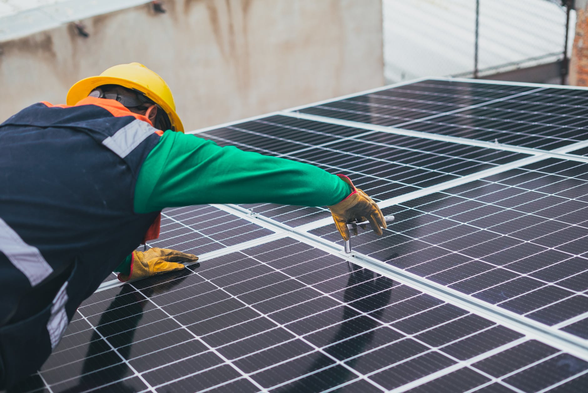 Engineer fitting solar panels on roof